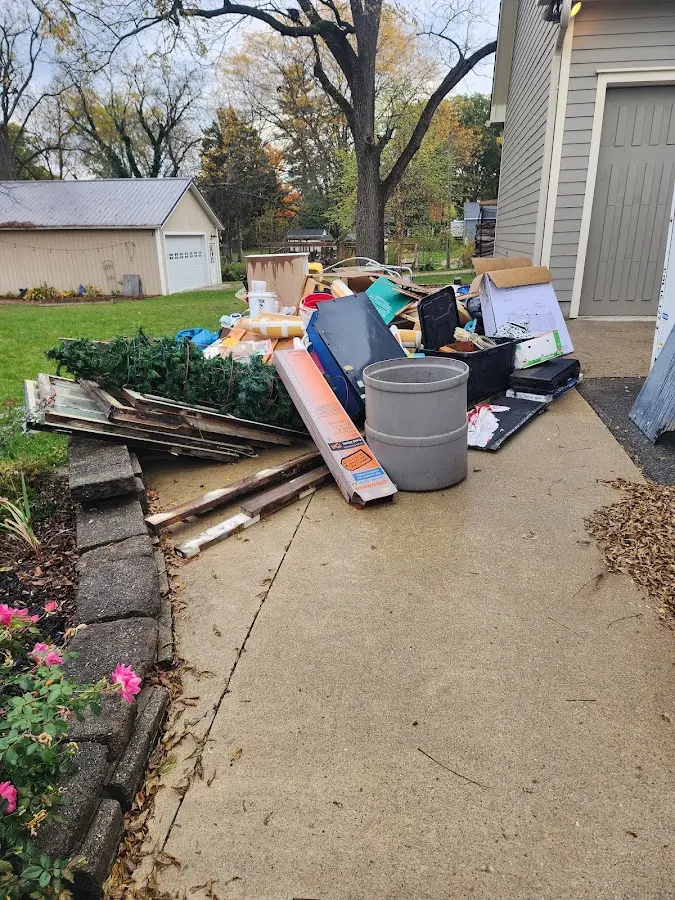 Dumpster being loaded with debris for 12 Yard Dumpster Rental in Northbridge